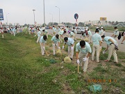Employees join in collecting rubbish around industrial park