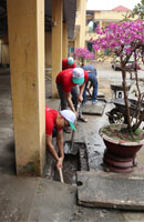 Tình nguyện viên khơi thông đường cống nước mưa
