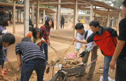 Volunteer members and pupils hand in hand clean environment
