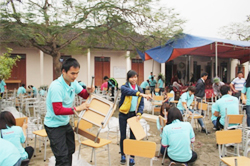 Tình nguyện viên hỗ trợ lắp ghép bàn ghế tại trường
